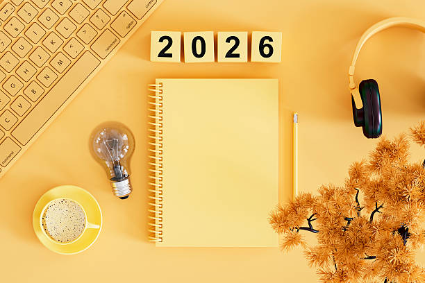 istock 2026 New Year, Lightbulb and Blank Page Notebook on Yellow Background, New Idea Concept 2229405033