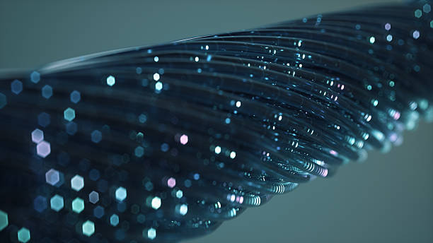 A bundle of fiber optic cables glows with streams of light particles. The image illustrates concepts of modern telecommunications, the internet, and futuristic data transmission.