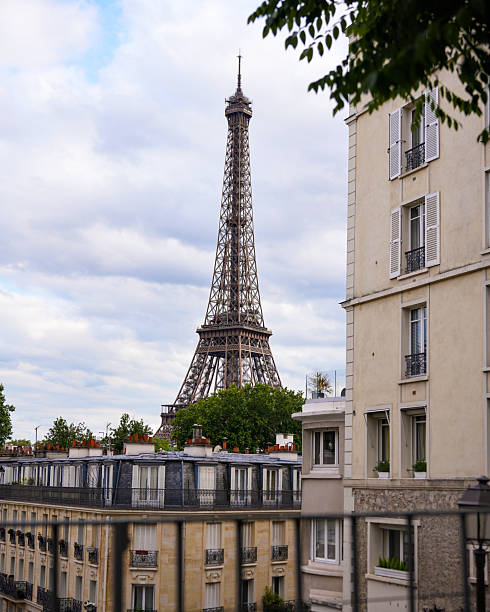 istock Eiffel Tower view framed by Parisian buildings on a cloudy day 2229406967