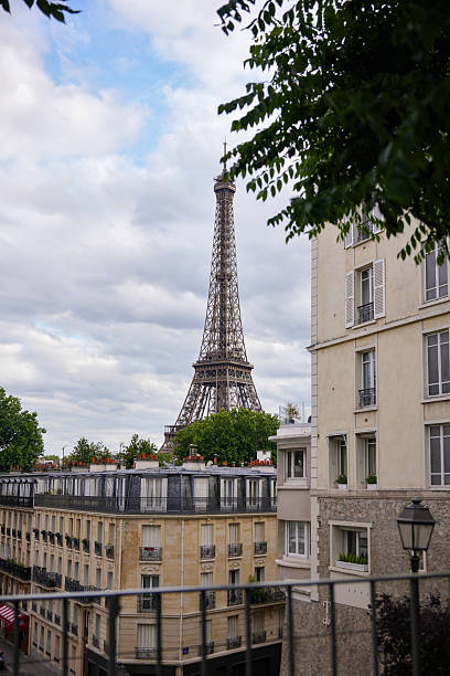 istock Eiffel Tower framed by Parisian residential buildings on cloudy day 2229407183