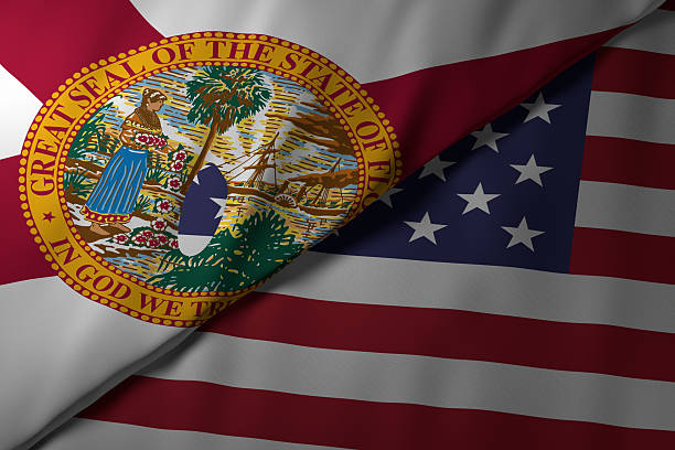 Close-up view of the Florida state flag alongside the United States national flag. The vibrant colors and fabric texture highlight the unity and identity of the state within the nation.