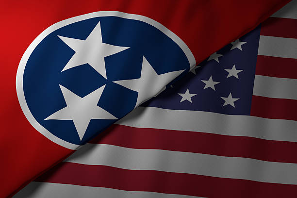 Close-up view of the Tennessee state flag alongside the United States national flag. The vibrant colors and fabric texture highlight the unity and identity of the state within the nation.