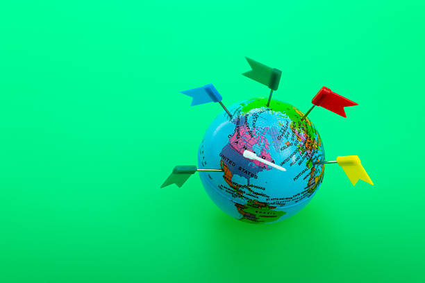 istock Colorful flag pins marks on plastic earth globe against green background 2229421590