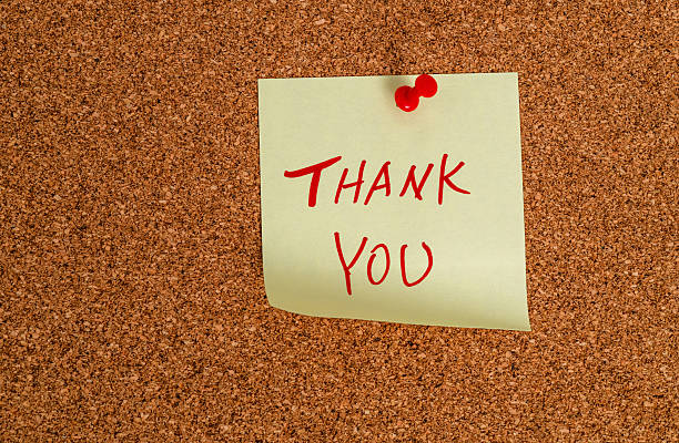 istock Thank you message on sticker note pin on cork wall 2229421832