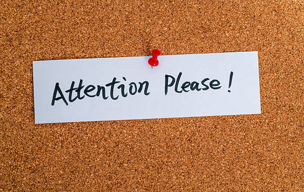 istock Attention please written on a piece of paper  on cork wall 2229421882