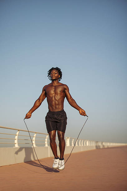 istock Fit man jumping rope outdoors on a sunny day during training session 2229424970