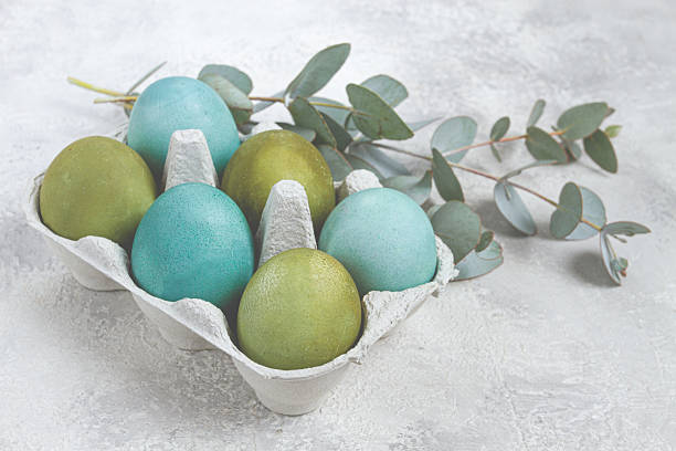 istock Easter colored eggs, in green and turquoise tones, with eucalyptus leaves, Easter card, top view, no people, 2229426115