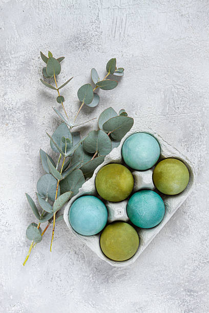 istock Easter colored eggs, in green and turquoise tones, with eucalyptus leaves, Easter card, top view, no people, 2229426869