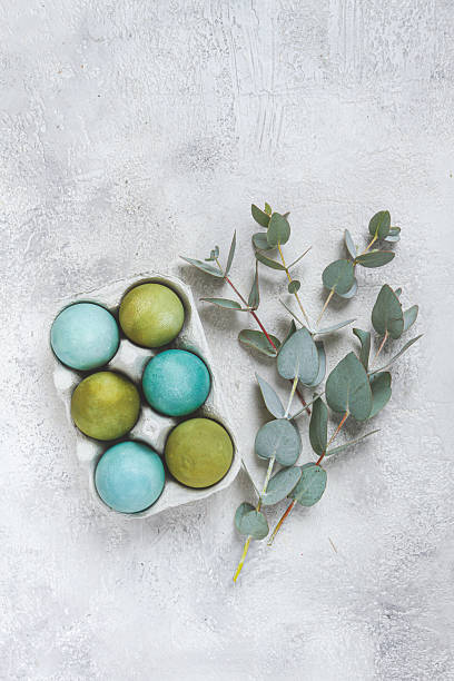 istock Easter colored eggs, in green and turquoise tones, with eucalyptus leaves, Easter card, top view, no people, 2229427456