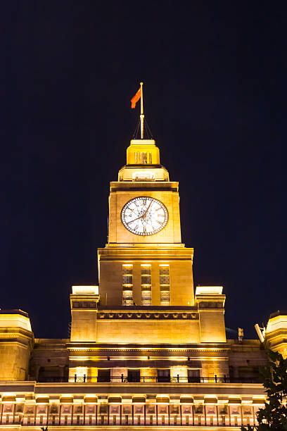 istock Illuminated clock tower on the custom building in Shanghai 2229428885
