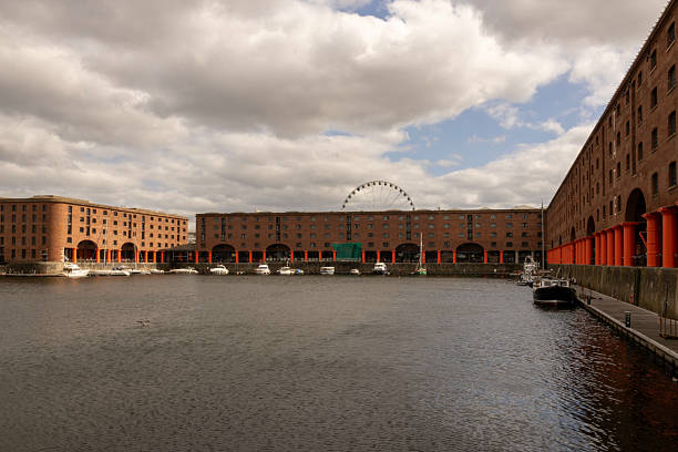A wide angle photograph of moored boats at Albert Docks in Liverpool, Northwest England. The photograph was created on a summer day