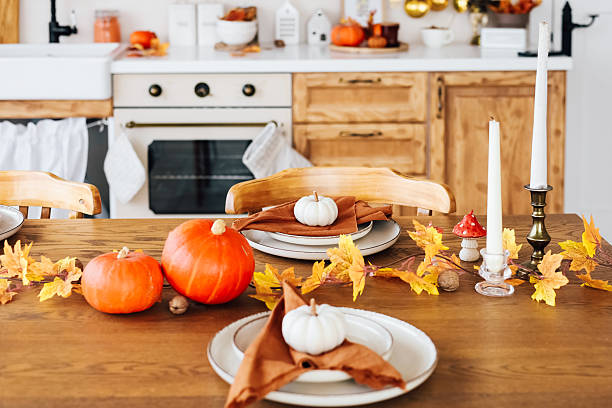 istock Cozy autumn kitchen decorated for Thanksgiving dinner with pumpkins and fall leaves 2229431187