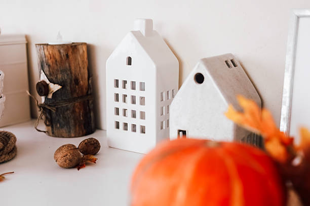 istock Autumn home decor featuring cozy houses and seasonal elements on a table setup 2229431279
