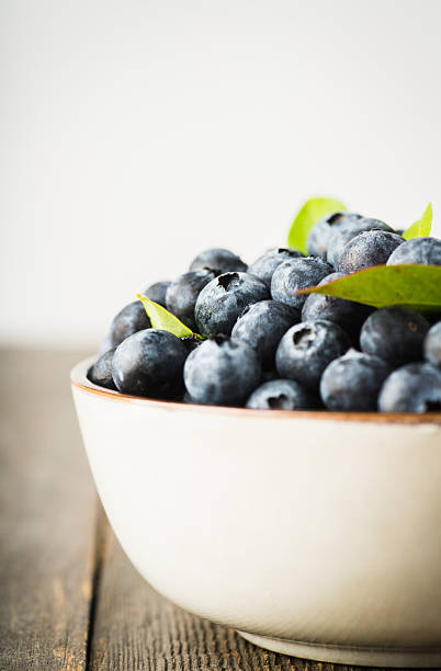 istock Fresh ripe garden blueberries in ceramic bowl 2229431322