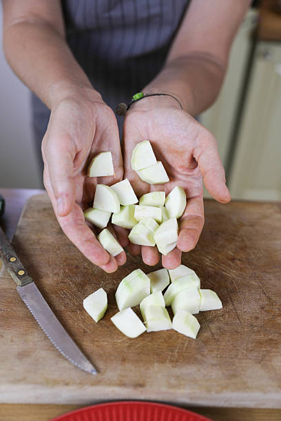 istock Senior Woman in Kitchen, Cutting Fresh Vegetables for a Nutritious Meal 2229432696