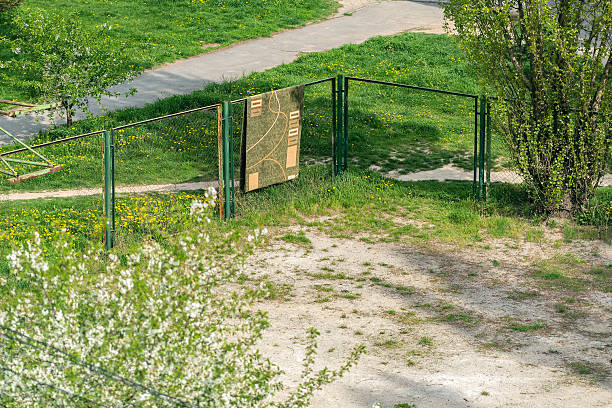 Green stadium fence with carpet hanging from it. stock photo