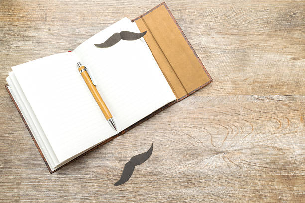 Happy Fathers day holiday concept, greeting card, open notebook for text with pen on a rustic wood background with copy space.