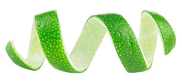istock Curly lime fruit zest isolated on a white background. Fresh lime fruit peel, cocktail ingredient. 2229436526
