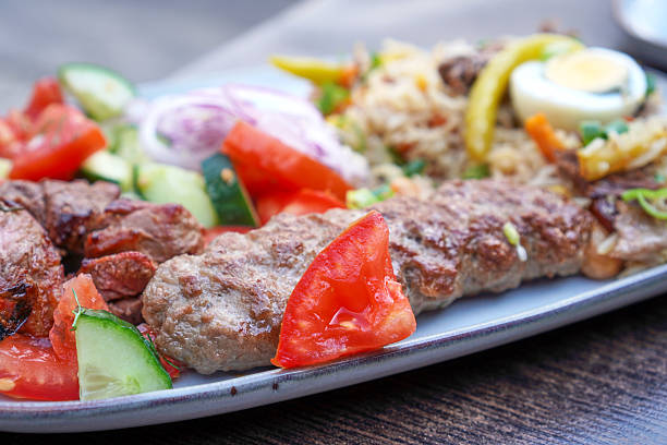 istock Kebab with rice and vegetables on a plate 2229437239