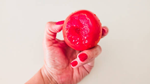 istock Bited Ripe Tomato in Hand on White Background 2229438389
