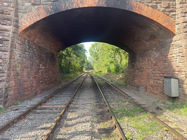 istock Railway Tracks Passing Under Historic Stone Bridge – West Somerset Railway 2229441032