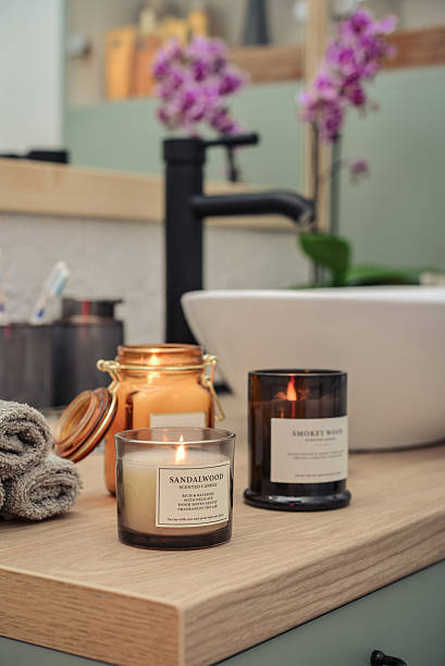 istock Burning candles in glass jars in modern bathroom 2229443459
