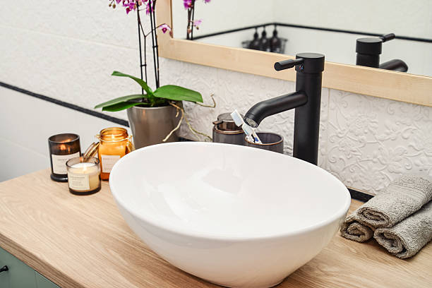 istock Stylish vessel sink with black basin mixer 2229443655