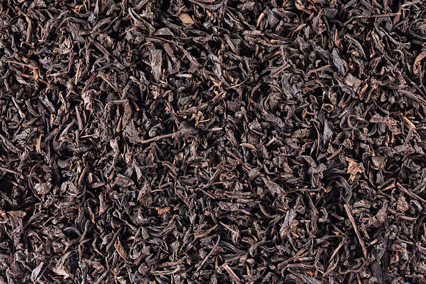Dried black tea leaves, shot from above background