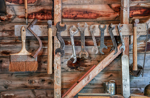 istock Vintage rustic hand tools hanging on wooden workshop wall for carpentry and repair 2229450622