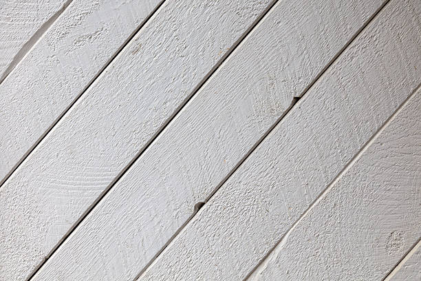 White painted wooden planks arranged diagonally showcase natural grain texture. Perfect rustic-modern background for interior design, coastal themes, and minimalist photography projects.