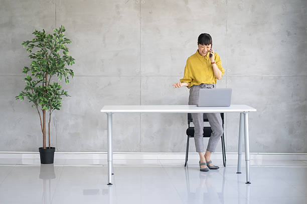 istock Professional Woman Engaged in Phone Call at Desk 2229457674