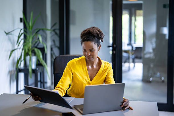 istock Young manager working with documents and laptop in modern office 2229457979