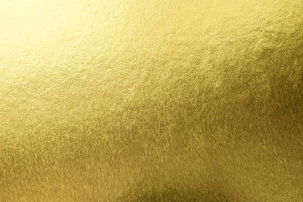 istock Gold background foil leaf metallic golden texture  gradient light shiny reflective wrapping paper bright yellow solid color wallpaper for design decoration element backdrop 2229458893