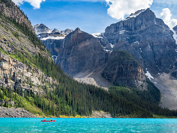 istock Turquoise Moraine Lake with pine forest and rugged mountain peaks 2229466816
