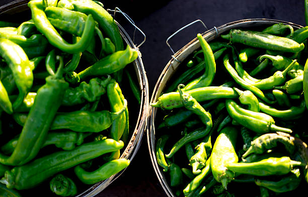 Two Sunlit Bushel Baskets of Green Chile Peppers (Close-Up). Shot in Santa Fe, NM.
