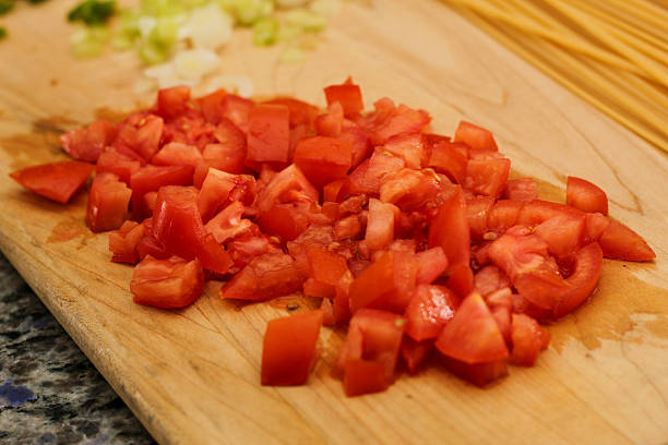 Uncooked Pasta and Fresh Vegetables on Wooden Cutting Board for Meal Prep