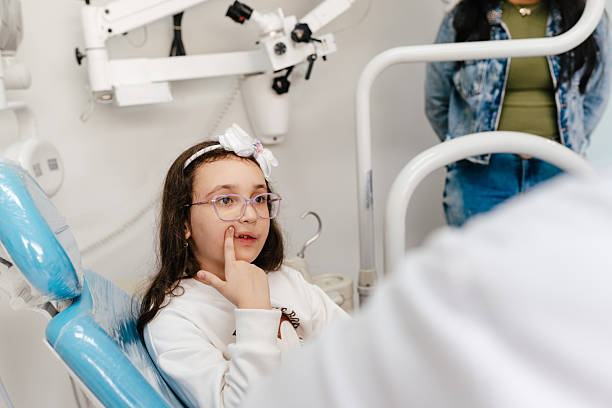 istock Child pointing at tooth in dental chair 2229468146