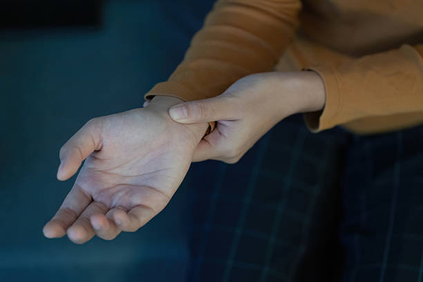 istock Health Awareness: Close-up of young woman's hand checking wrist 2229469553