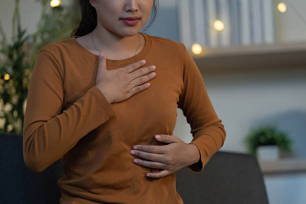 istock Health Awareness: Young woman feeling abdominal discomfort at home 2229469612
