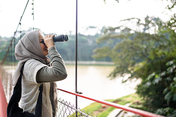 istock Young woman with binoculars in the mountains 2229469684