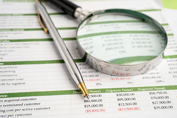 istock Magnifying glass on data business graphs paper. 2229470668