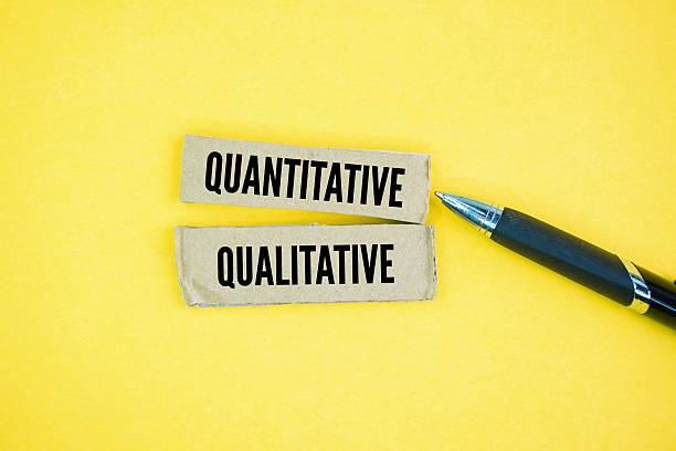 istock Pen and paper with the words quantitative and qualitative. Quantitative data deals with numbers and statistics, while qualitative data focuses on descriptions and meanings. 2229472272