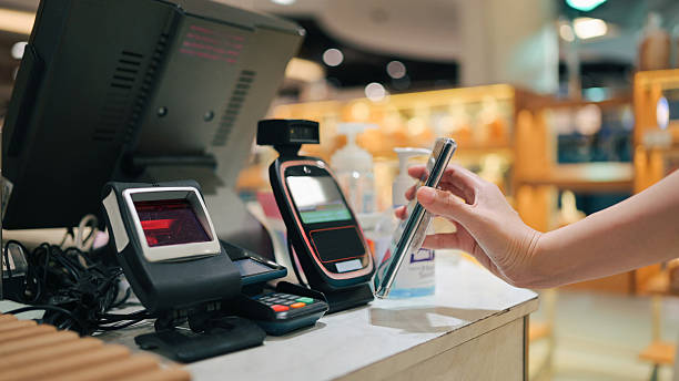 istock customer using smartphone for nfc contactless payment at retail pos terminal in shopping mall 2229472357
