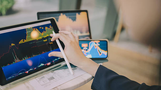 istock Trader investors adjust ai collaboration seamlessly working across multiple digital devices AI productivity investment tele-finance working ecosystem 2229474144