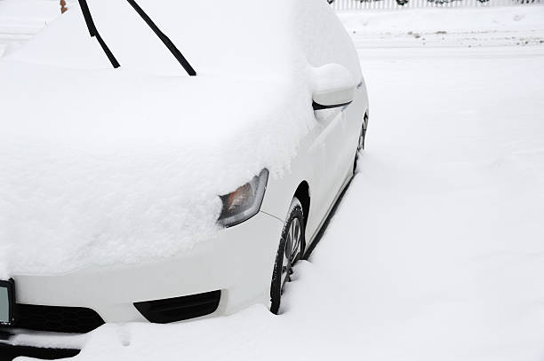istock car covered by snow after blizzard 2229474316