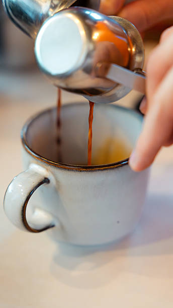 istock Barista pouring espresso coffee into a cup from a portafilter 2229477613