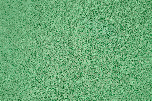 Textured Green Surface With a Soft, Granular Appearance Suitable for Various Applications or Artistic Endeavors