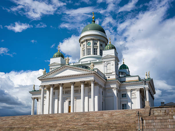 Famous Helsinki Cathedral in Summer, a landmark in the Finnish Capital, rises majestically against a backdrop of blue sky and white clouds. Hasselblad X2D 100 MPixel Architecture Shot of the iconic Helsinki Cathedral with historic 19th century Evangelical Lutheran Cathedral. Old Town Helsinki in Summer, Senate Square, Kruununhaka, Finland, Nordic Countries, Northern Europe, Nordic Countries