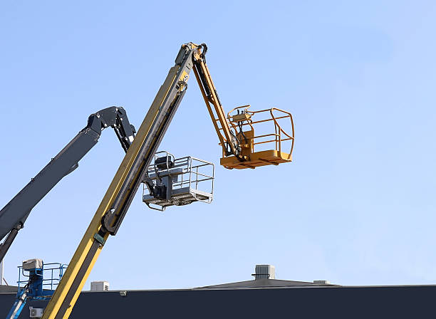 istock Aerial working platforms of cherry pickers over a roof. 2229491822