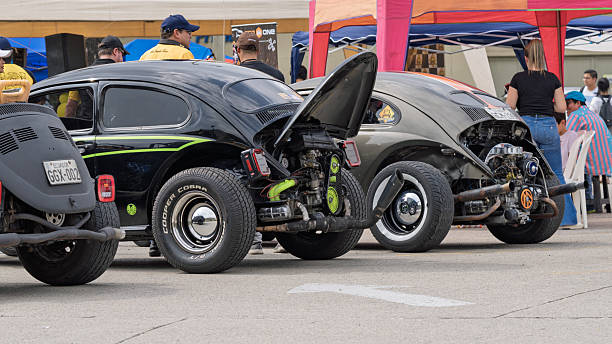Guayaquil, Ecuador – June 23rd, 2024: Customized Volkswagen Beetles, one in buggy style and another with exposed engine.
